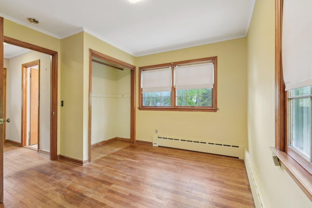 54 Cedar St, Stony Brook, NY 11790 - unfurnished bedroom with a baseboard radiator, light wood-type flooring, multiple windows, ornamental molding, and baseboards
