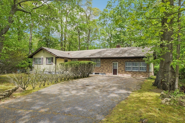 54 Cedar St, Stony Brook, NY 11790 - view of front of house featuring driveway, a chimney, and brick siding