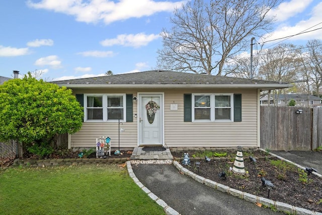 133 Parkwood Dr, Shirley, NY 11967 - bungalow-style home featuring a front lawn and fence