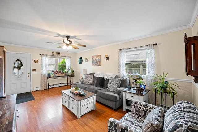 133 Parkwood Dr, Shirley, NY 11967 - living area featuring light wood finished floors, ceiling fan, ornamental molding, and a baseboard heating unit