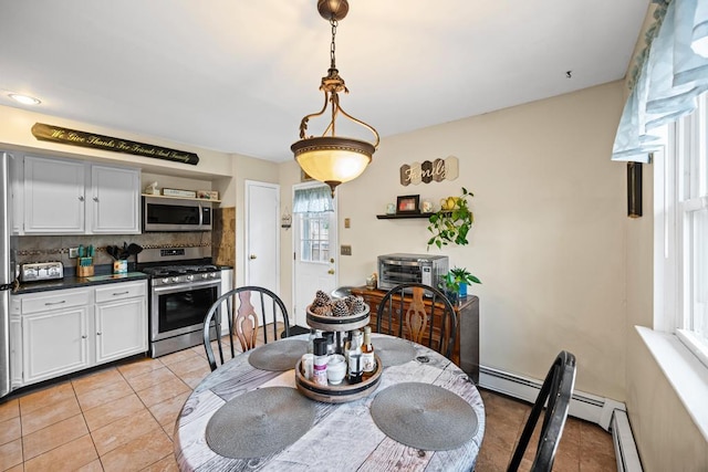 133 Parkwood Dr, Shirley, NY 11967 - dining room featuring a wealth of natural light, light tile patterned flooring, and a baseboard heating unit