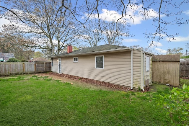 133 Parkwood Dr, Shirley, NY 11967 - view of home's exterior featuring a chimney, a yard, fence private yard, and an outbuilding