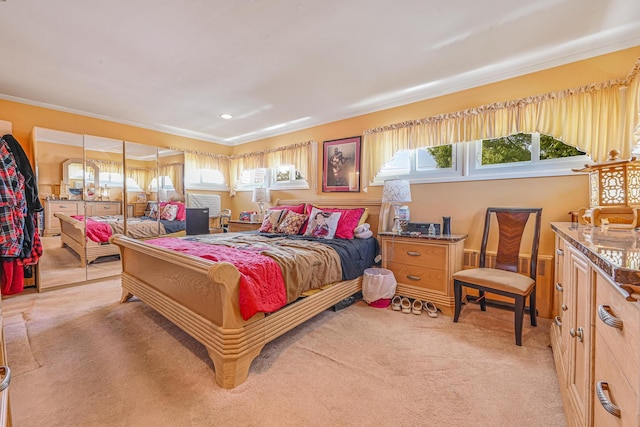 bedroom with ornamental molding and light carpet