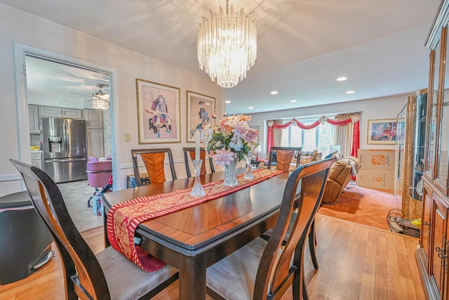 dining space with recessed lighting, a chandelier, and light wood-type flooring