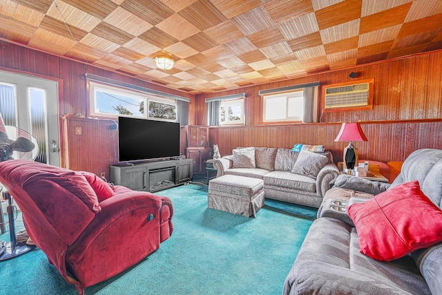 carpeted living area featuring wooden ceiling, wood walls, and plenty of natural light