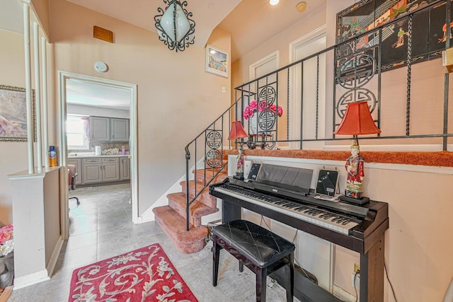 interior space with stairway and baseboards