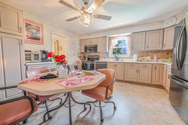 kitchen featuring a ceiling fan, backsplash, light countertops, stainless steel appliances, and wallpapered walls