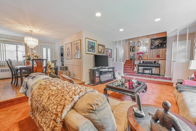 carpeted living room featuring an inviting chandelier, recessed lighting, and radiator