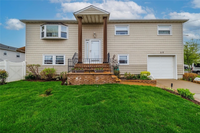 68 Lincoln Ave, Island Park, NY 11558 - view of front of property featuring driveway, fence, a front lawn, and an attached garage
