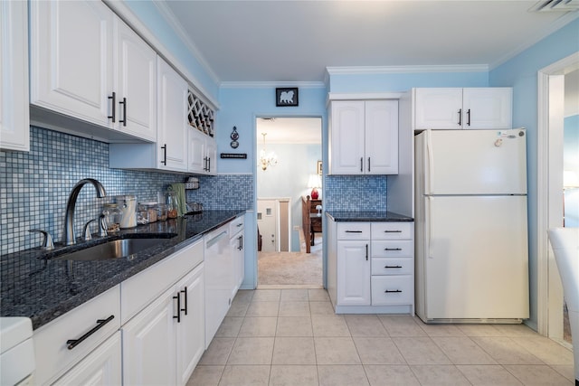 68 Lincoln Ave, Island Park, NY 11558 - kitchen with dark stone counters, white cabinets, white appliances, and a sink