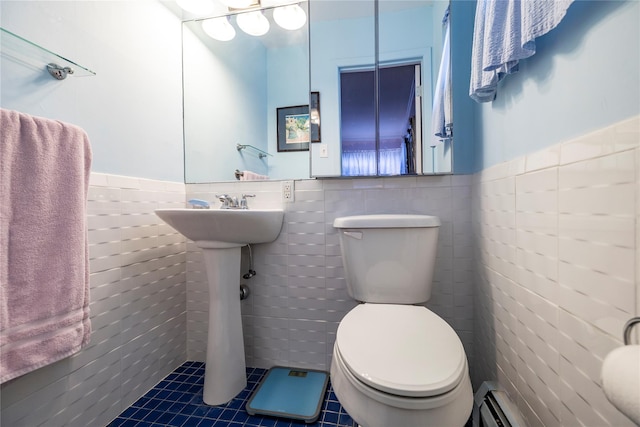 68 Lincoln Ave, Island Park, NY 11558 - bathroom with toilet, a wainscoted wall, tile walls, and tile patterned floors