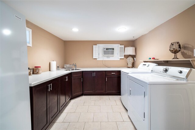 68 Lincoln Ave, Island Park, NY 11558 - laundry room with a sink, cabinet space, a wall unit AC, light tile patterned floors, and separate washer and dryer