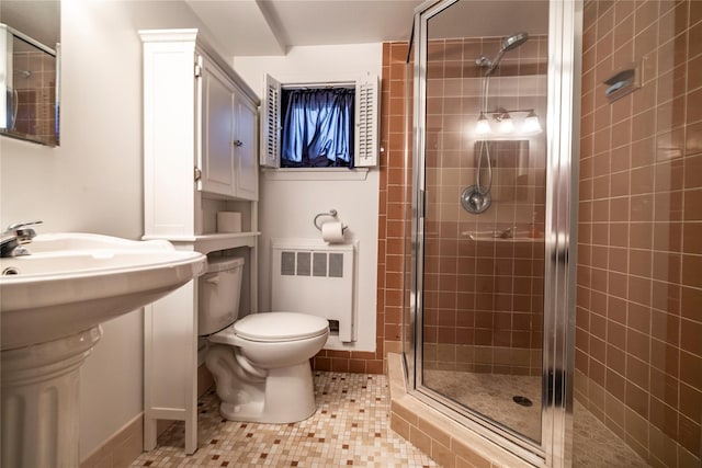 68 Lincoln Ave, Island Park, NY 11558 - bathroom with radiator, a sink, tile patterned floors, toilet, and a stall shower