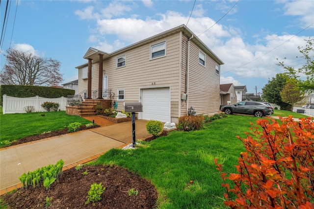 68 Lincoln Ave, Island Park, NY 11558 - view of side of property with driveway, a yard, a garage, and fence