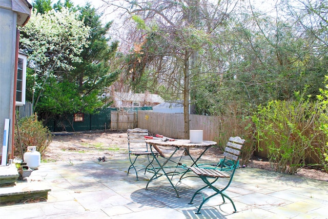 view of patio with outdoor dining space and a fenced backyard