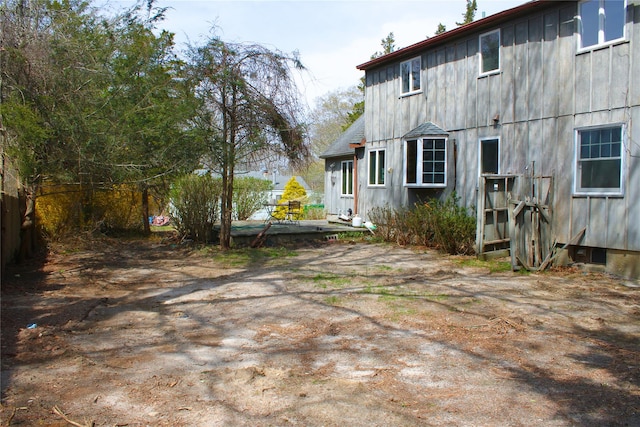 view of side of property featuring board and batten siding and a wooden deck
