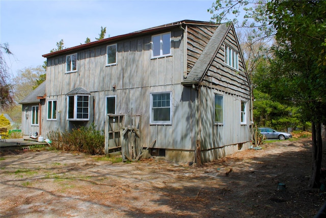rear view of house featuring board and batten siding