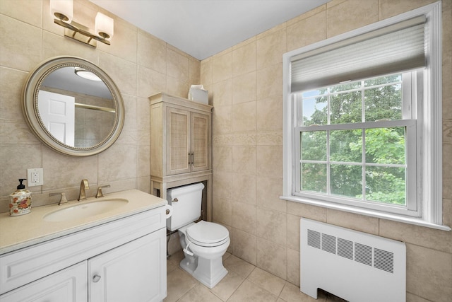 97 Highview Ave, Tuckahoe, NY 10707 - bathroom with radiator, tile walls, tile patterned floors, vanity, and toilet
