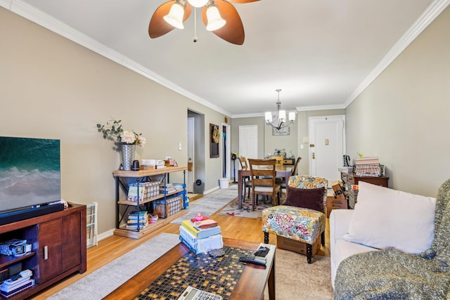 200 N Village Ave Unit D10, Rockville Centre, NY 11570 - living area featuring light wood-type flooring, ornamental molding, baseboards, and ceiling fan with notable chandelier