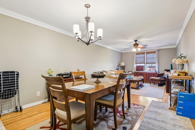 200 N Village Ave Unit D10, Rockville Centre, NY 11570 - dining space featuring crown molding, baseboards, ceiling fan with notable chandelier, and light wood finished floors