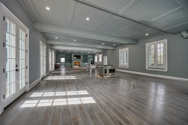interior space featuring wood finished floors, baseboards, french doors, and a fireplace