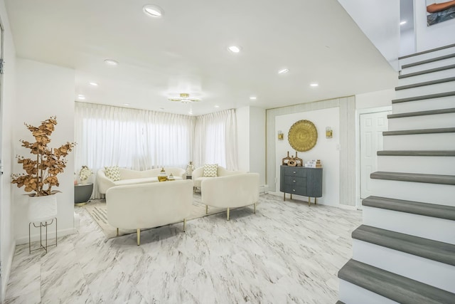 living area featuring stairs, recessed lighting, baseboards, and marble finish floor