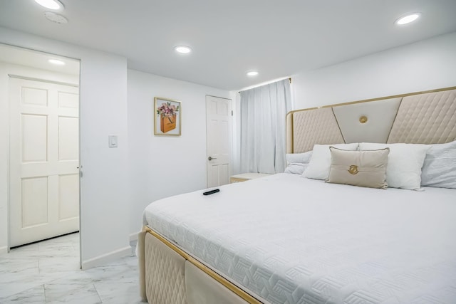 bedroom featuring recessed lighting, marble finish floor, and baseboards