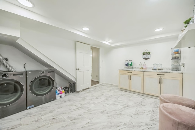 washroom featuring recessed lighting, marble finish floor, and washer and clothes dryer