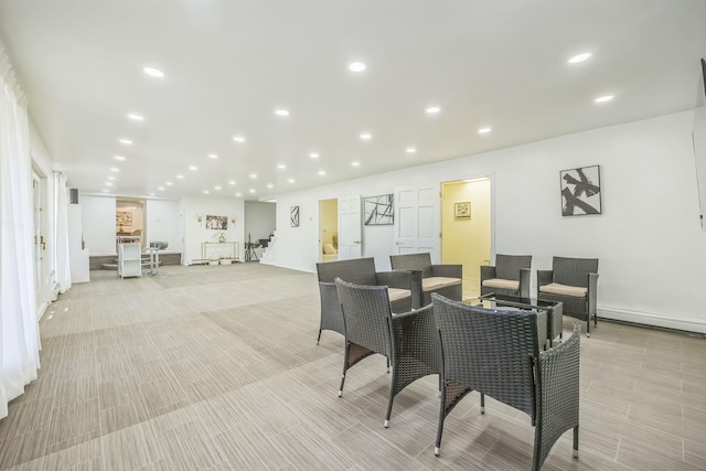 dining room with recessed lighting, baseboards, light wood-style flooring, and a baseboard radiator