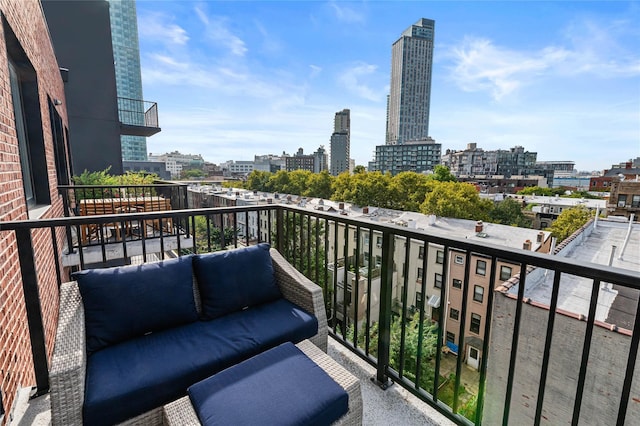 balcony featuring a view of city and an outdoor living space