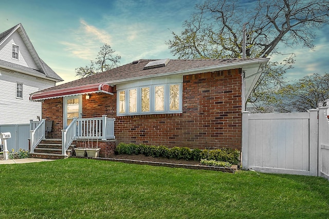 1036 Pacific St, Baldwin Harbor, NY 11510 - view of front of home featuring brick siding, fence, a shingled roof, and a front yard
