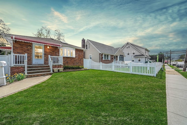 1036 Pacific St, Baldwin Harbor, NY 11510 - view of front of house with brick siding, fence, and a front lawn