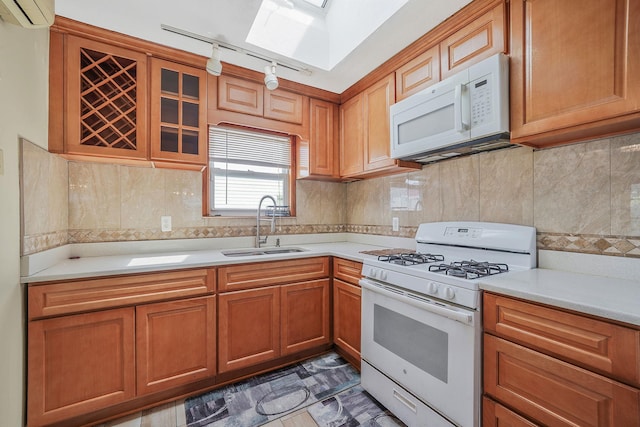 1036 Pacific St, Baldwin Harbor, NY 11510 - kitchen with white appliances, light countertops, a wall mounted AC, rail lighting, and a sink