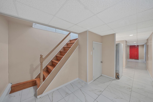 1036 Pacific St, Baldwin Harbor, NY 11510 - stairs featuring baseboards, marble finish floor, and a drop ceiling