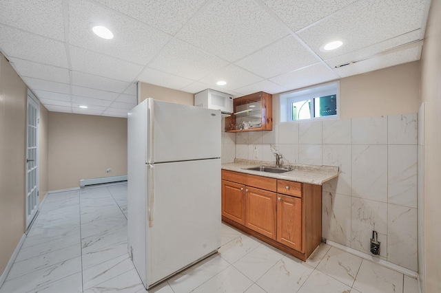 1036 Pacific St, Baldwin Harbor, NY 11510 - kitchen with a sink, freestanding refrigerator, baseboard heating, and marble finish floor