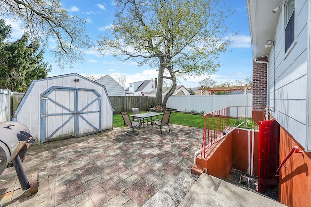1036 Pacific St, Baldwin Harbor, NY 11510 - view of patio with an outdoor structure, a fenced backyard, a shed, and outdoor dining space
