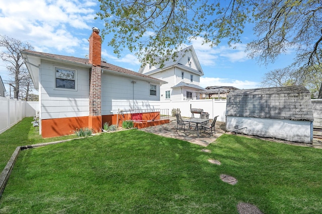 1036 Pacific St, Baldwin Harbor, NY 11510 - back of property with a lawn, a patio, a chimney, and a fenced backyard