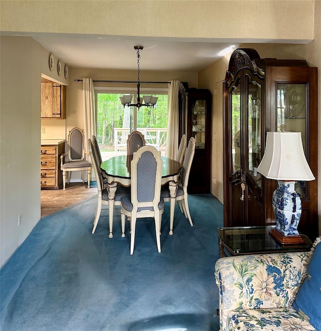 carpeted dining room featuring a notable chandelier