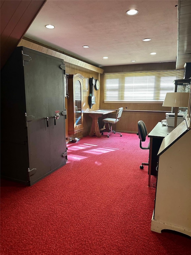 home office featuring recessed lighting, carpet flooring, and wood walls