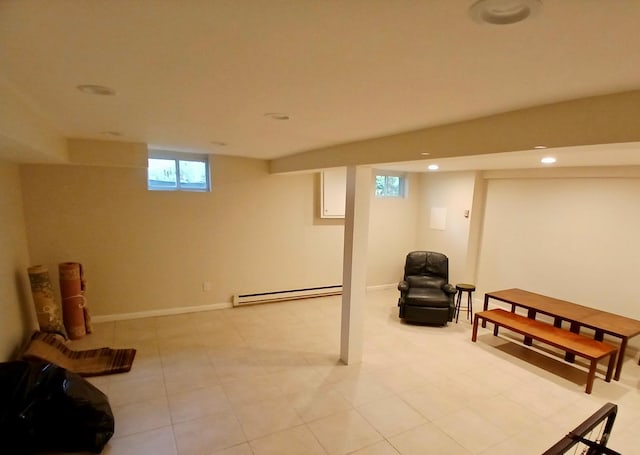 basement featuring recessed lighting, baseboards, and a baseboard heating unit