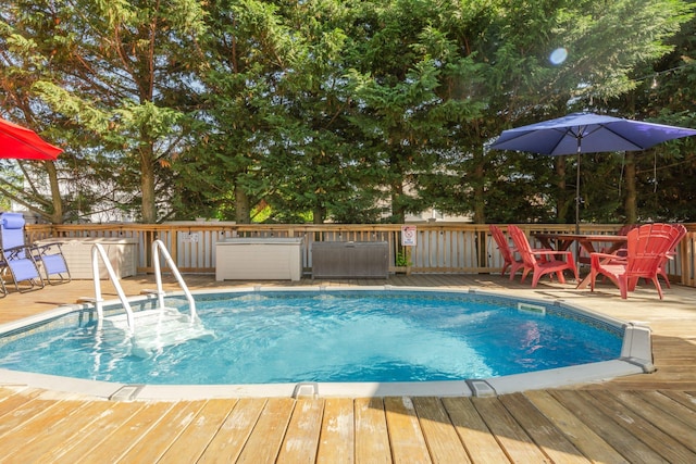 view of swimming pool featuring a wooden deck