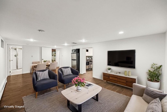 living area featuring wood finished floors, recessed lighting, and baseboards