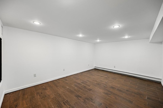 finished basement featuring recessed lighting, dark wood-style flooring, baseboards, and a baseboard radiator