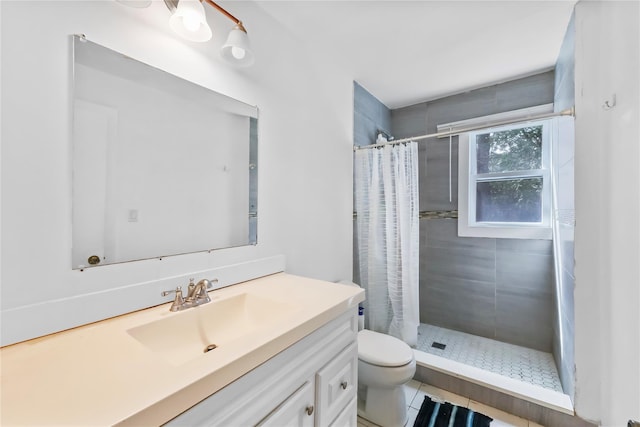 bathroom featuring vanity, tile patterned flooring, a stall shower, and toilet