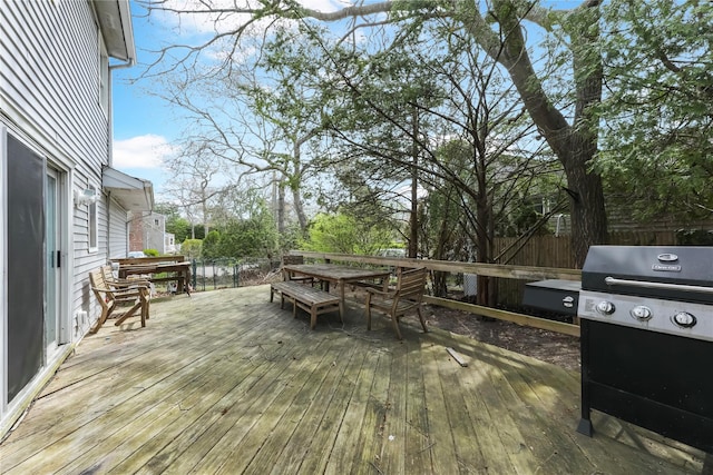 wooden terrace featuring outdoor dining area and fence