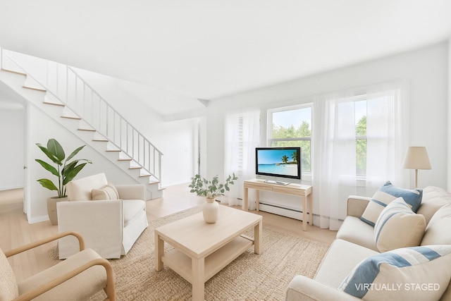60 School St, Hampton Bays, NY 11946 - living room featuring stairway, wood finished floors, and a baseboard radiator