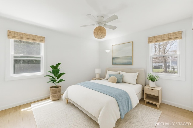 60 School St, Hampton Bays, NY 11946 - bedroom with multiple windows, light wood-style floors, and ceiling fan