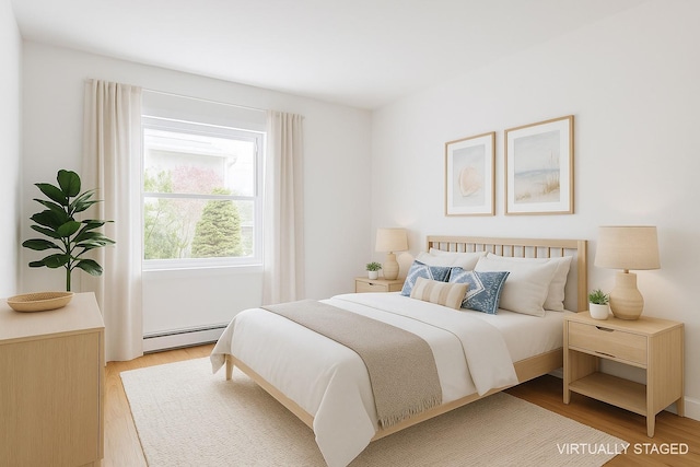 60 School St, Hampton Bays, NY 11946 - bedroom featuring light wood-type flooring and baseboard heating