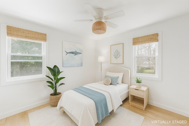 60 School St, Hampton Bays, NY 11946 - bedroom featuring multiple windows, wood finished floors, and ceiling fan