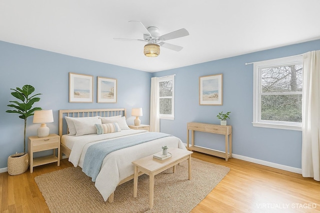 60 School St, Hampton Bays, NY 11946 - bedroom with light wood-style floors and ceiling fan